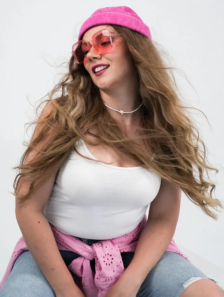 Chiki Piki team member in a pink beanie and rose-tinted glasses